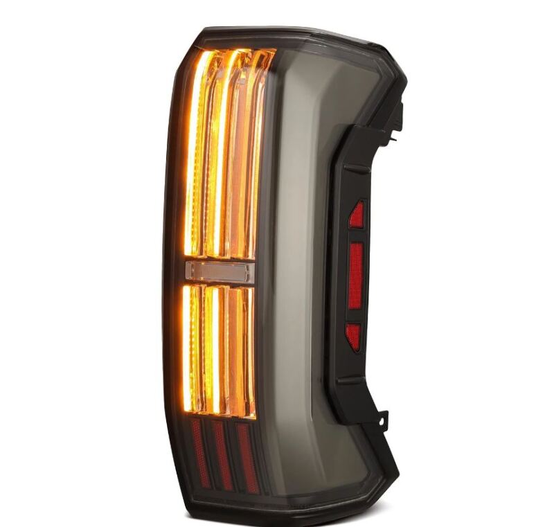 AlphaRex NOVA-Series prismatic LED tail light for 22-24 Toyota Tundra in alpha-black finish, featuring bright amber turn signals.