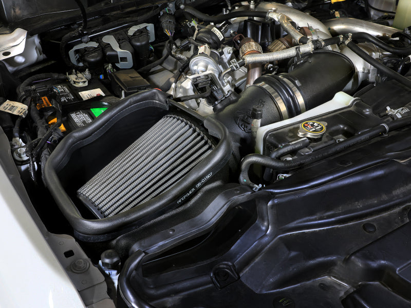 Open element intake system for Ford diesel trucks, showcasing the afe Magnum FORCE filter in an engine compartment.