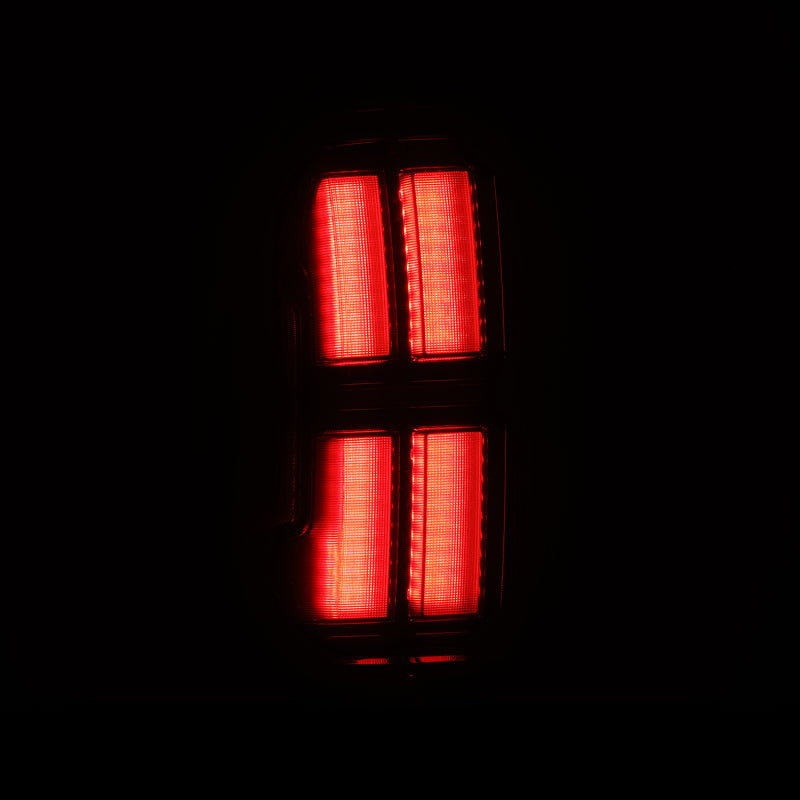 AlphaRex NOVA Prismatic LED tail lights for 05-15 Toyota Tacoma in Alpha-Black, showcasing a sleek red illumination design.