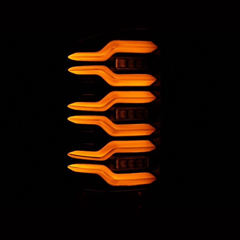 AlphaRex LUXX-Series LED tail lights for 14-18 GMC Sierra with black housing and sequential amber signal lights.
