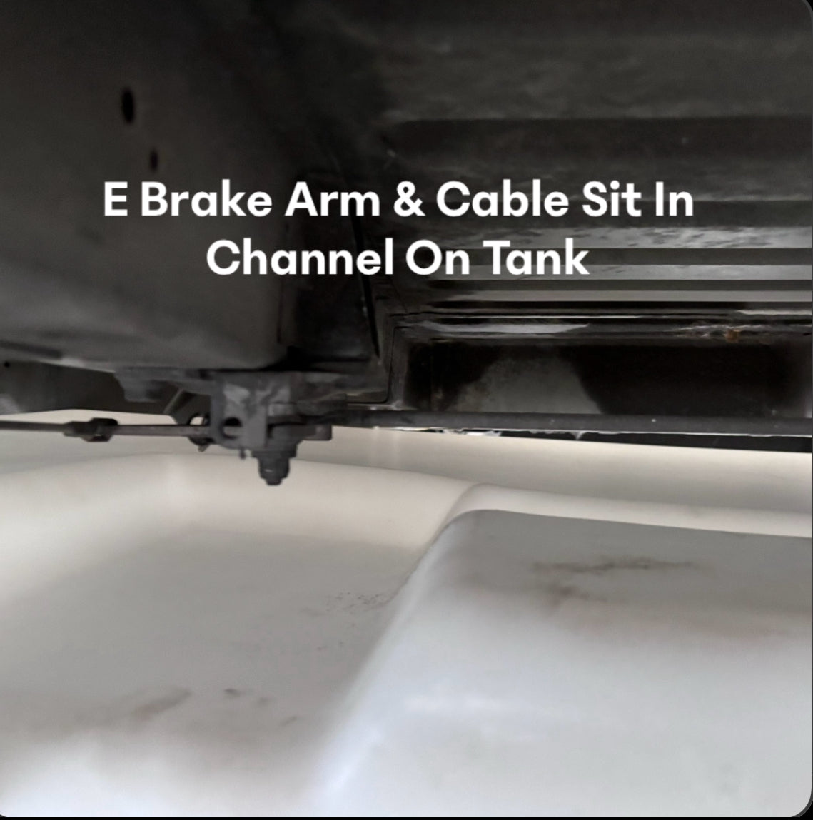 Undercarriage view of a 36-gallon fresh/grey water tank for Ford and Dodge/Ram models, showing E-brake arm and cable channel.