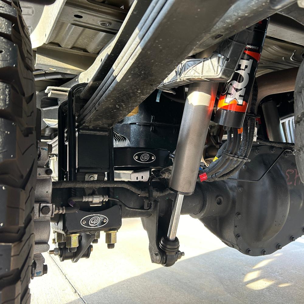 3.5-5.5 inch lift kit installed on a 2023 F250/F350, showcasing suspension components and shock absorbers for offroad performance.