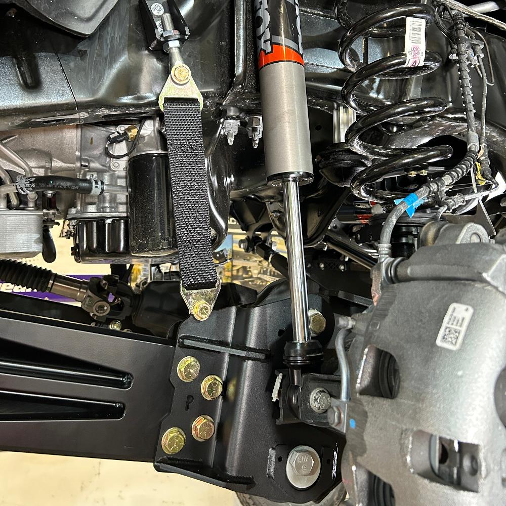 Close-up of a 2.5-inch fully loaded suspension kit installed on a 2023 F250/F350, showcasing components and hardware.