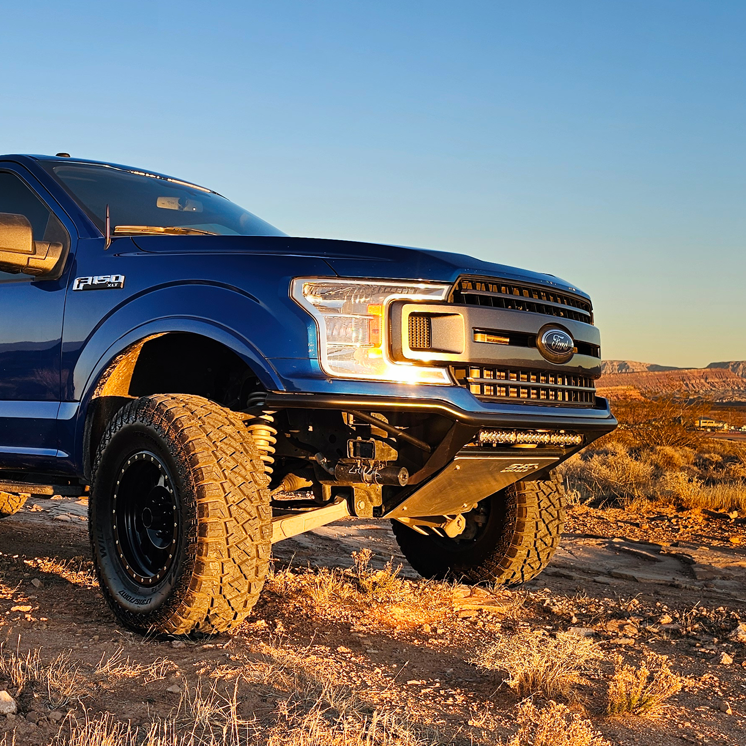 2018-2020 Ford F150 Baja bumper installed on a blue truck in a desert landscape, showcasing rugged offroad capability.