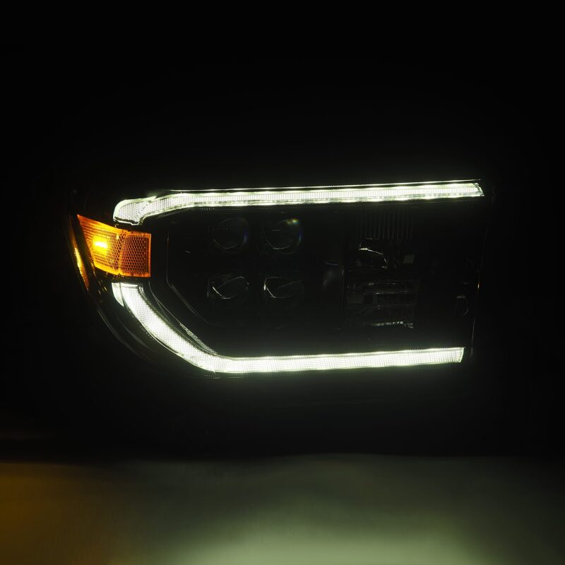 AlphaRex NOVA LED projector headlights for 07-13 Toyota Tundra in black with sequential signal and DRL features.