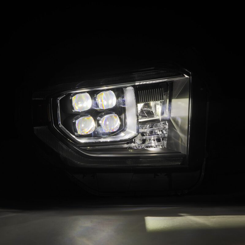 AlphaRex NOVA-Series LED projector headlights for 2014-2021 Toyota Tundra, featuring black housing, sequential signals, and DRL.