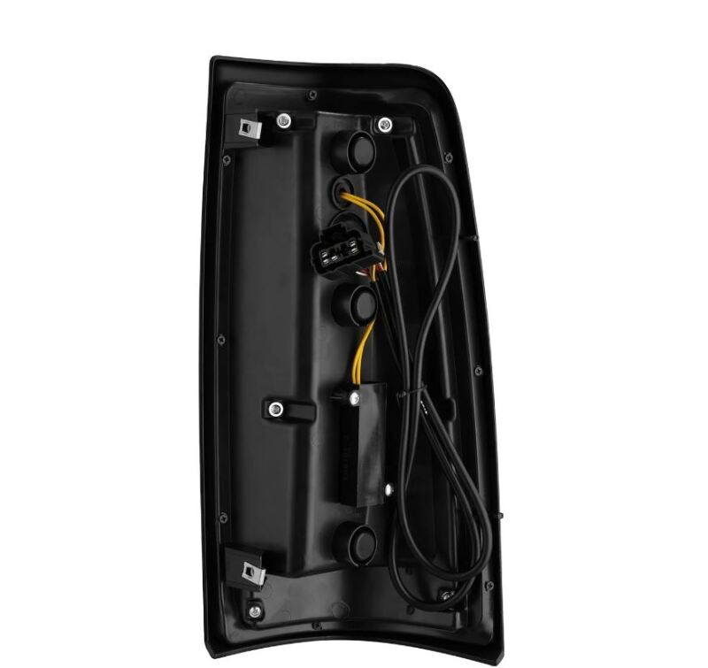 AlphaRex LUXX-Series LED tail lights for 99-06 Chevrolet Silverado and GMC Sierra in black, showcasing the rear view and wiring.