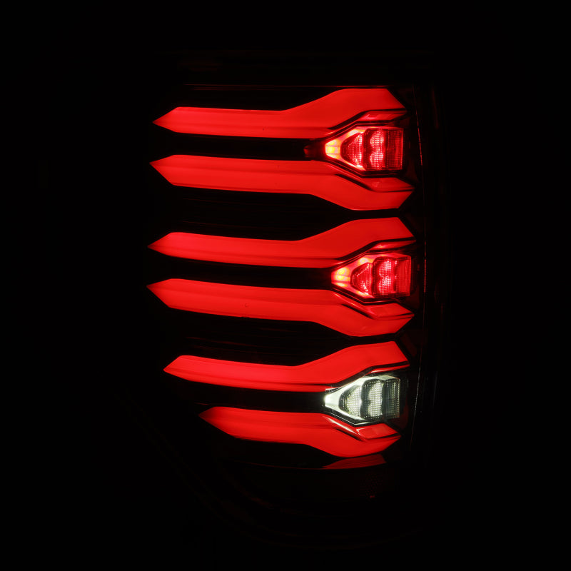 AlphaRex LUXX LED taillights for 09-14 Ford F150 in AlphaBlack housing, featuring a sleek, modern design with bright red illumination.