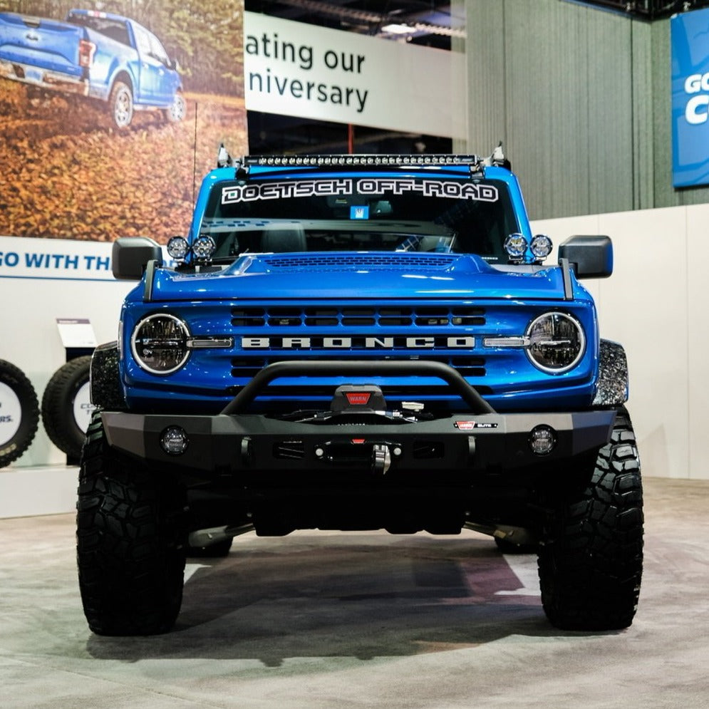 2021-2025 Ford Bronco with Ram Air Hood showcasing a bold design and off-road features in a trade show setting.
