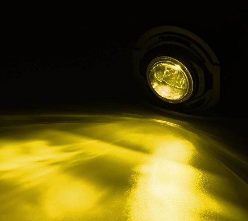 AlphaRex dual color LED projector fog light for 2015-2023 Dodge Charger, showcasing bright yellow illumination.