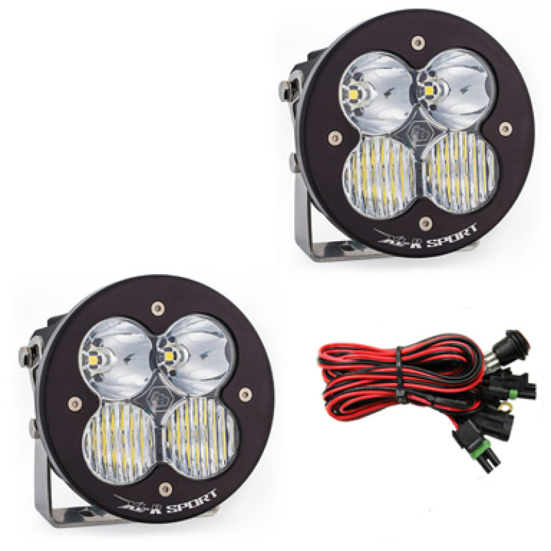 Baja Designs XL R Sport Series LED light pods with clear lenses, featuring a driving combo pattern and wiring harness.