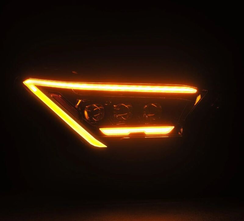 AlphaRex 2024 Toyota Tacoma NOVA-Series projector headlights in black with activation light, showcasing a sleek design.