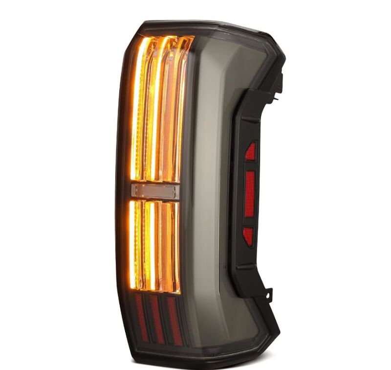 AlphaRex NOVA-Series black LED tail light for 2022-2024 Toyota Tundra, featuring a prismatic design and bright amber signals.