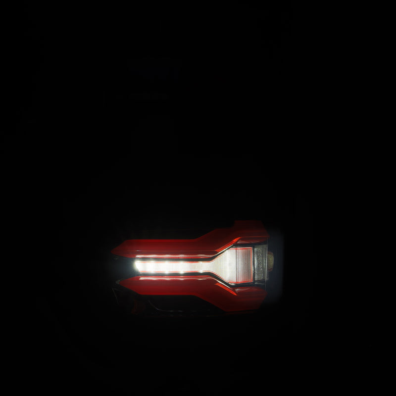 AlphaRex LUXX LED taillights for 21-23 Ford F-150 in black and red with BLIS feature, showcasing a sleek design.