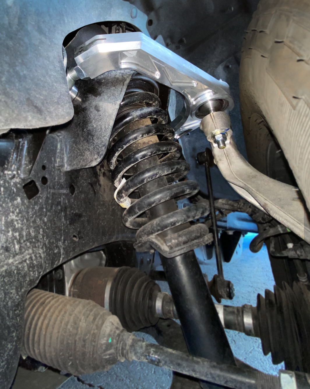 Billet upper control arm kit installed on a 2015-2024 Ford F-150, showcasing stock length suspension components.