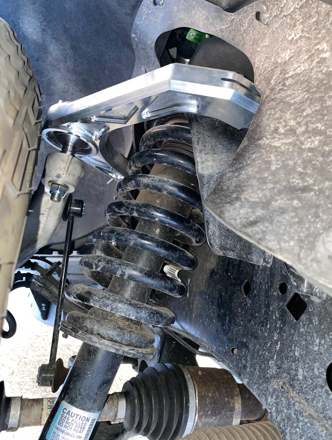 Billet upper control arm kit installed on a 2015-2024 Ford F-150, showcasing stock length suspension components.