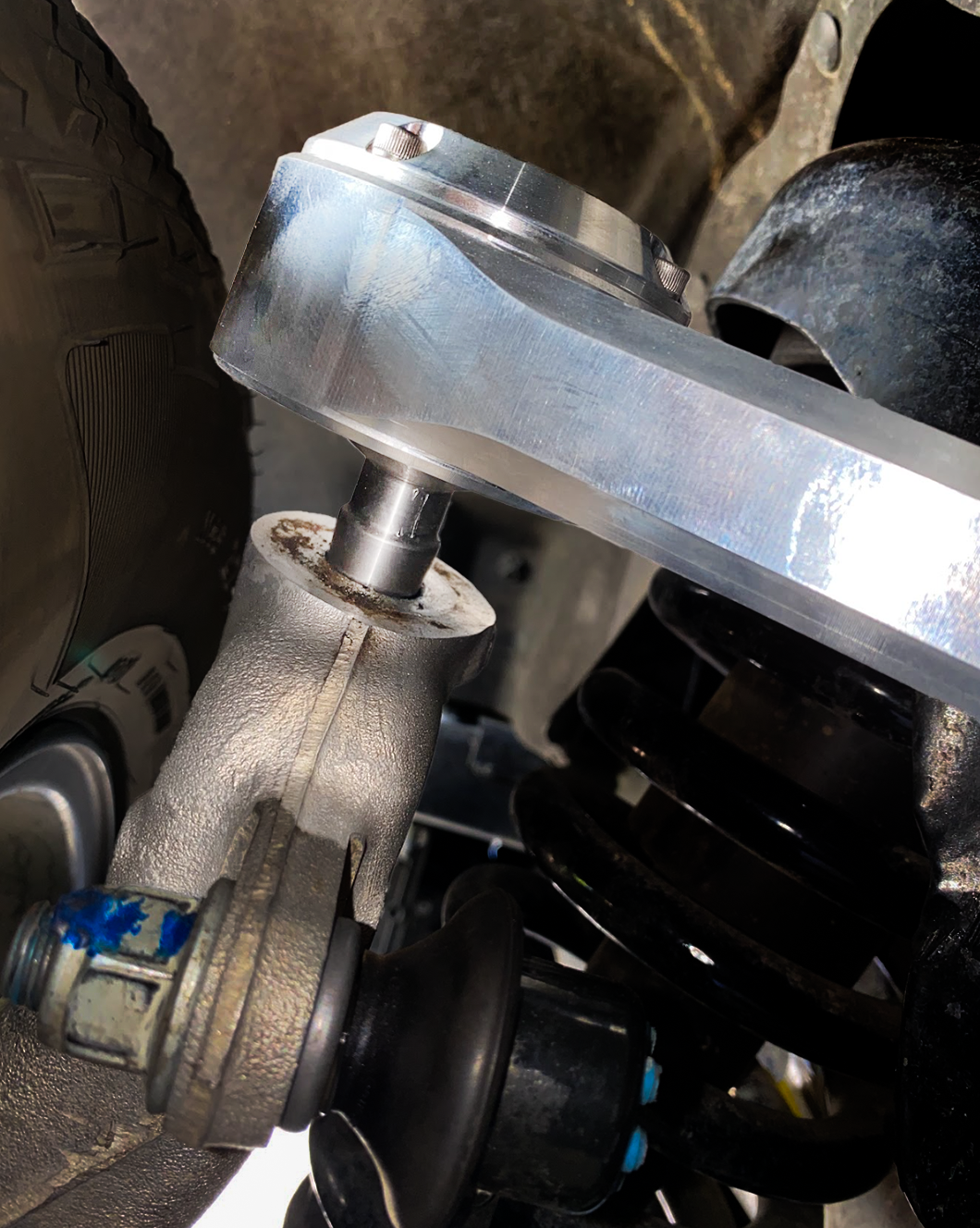 Close-up of a 2015-2024 Ford F-150 billet upper control arm kit, showcasing stock length and precision engineering details.