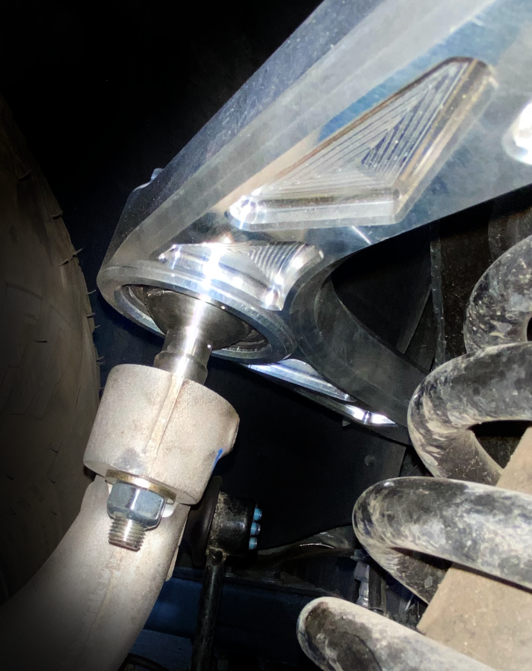 Close-up view of a billet upper control arm kit for 2015-2024 Ford F-150, showcasing stock length design and mounting details.