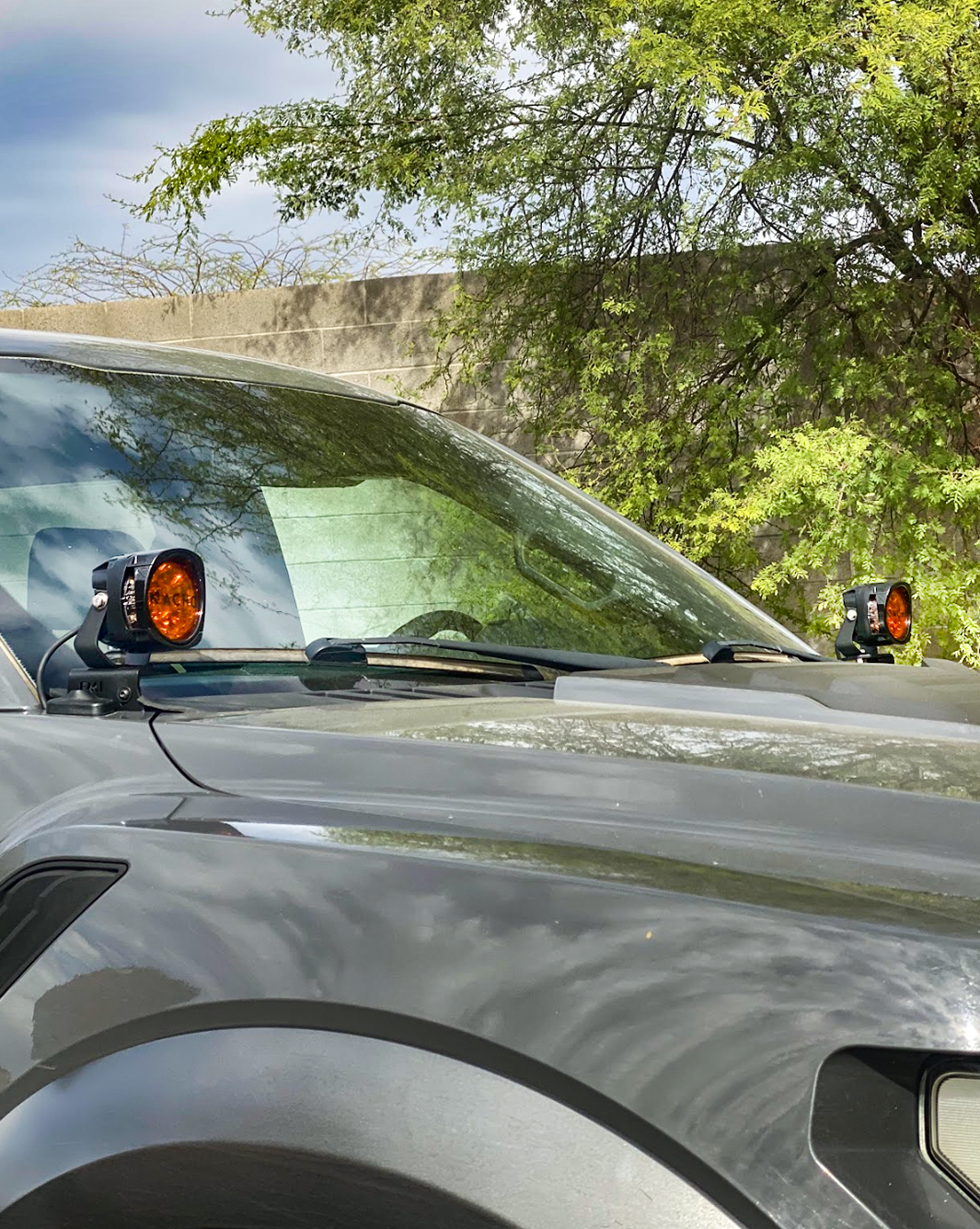 Front A-Pillar light mount kit for 2017-2020 Gen 2 Raptor, featuring two mounted lights on the vehicle's hood.