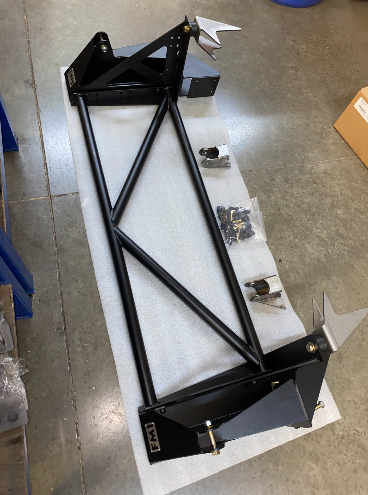 Raptor rear bed cage shock tower designed for 20.25-inch wheel travel, featuring a sturdy black metal frame and mounting hardware.
