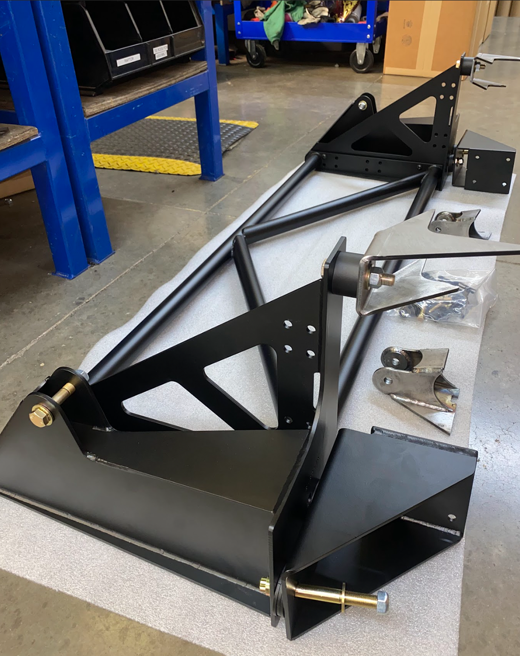 Raptor rear bed cage shock tower designed for 20.25-inch wheel travel, featuring durable black metal construction and mounting hardware.