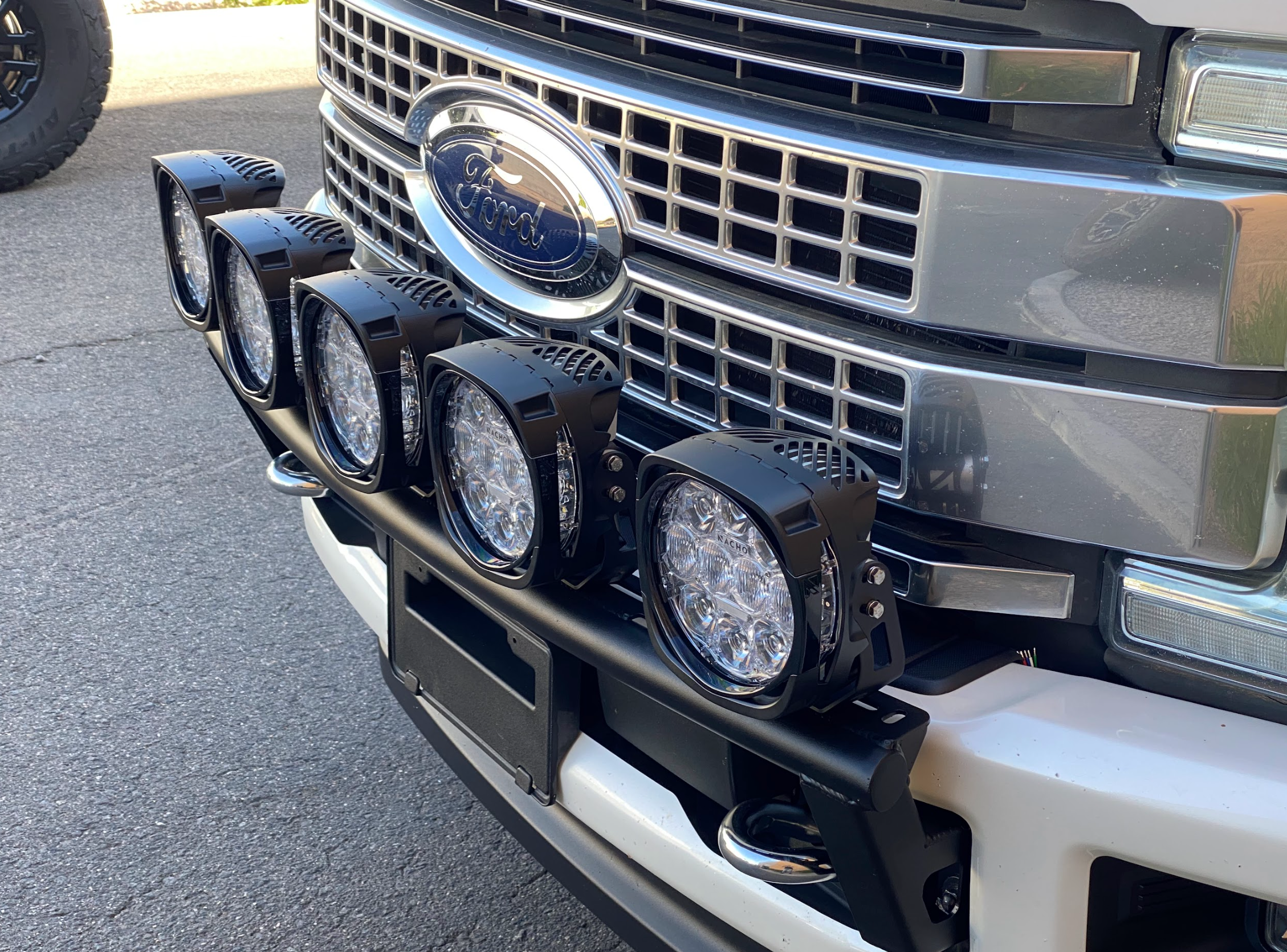 Front light mount kit for 2017-2022 Ford F-250 Super Duty, featuring five mounted lights on a stock bumper.