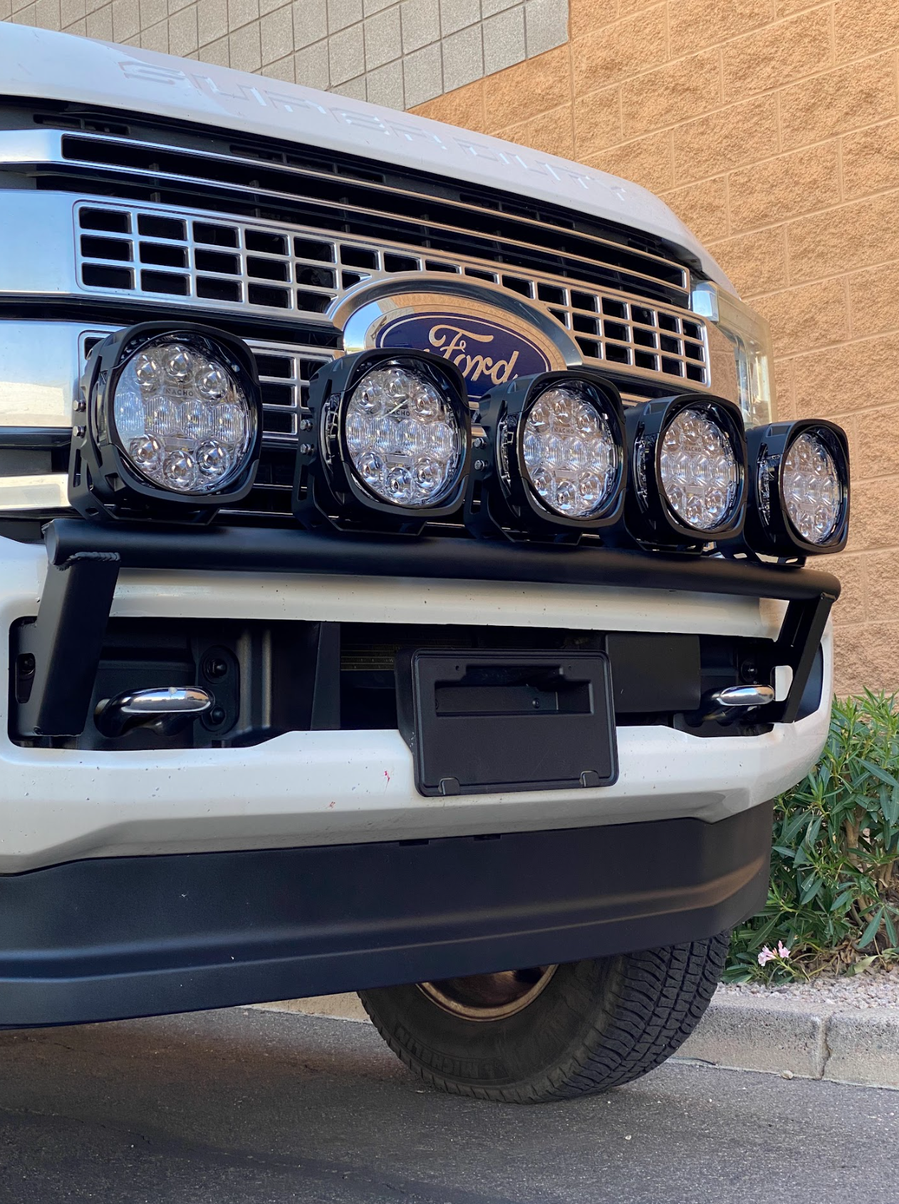 Front light mount kit for 2017-2022 Ford F-250 Super Duty, featuring five LED lights on a stock bumper.