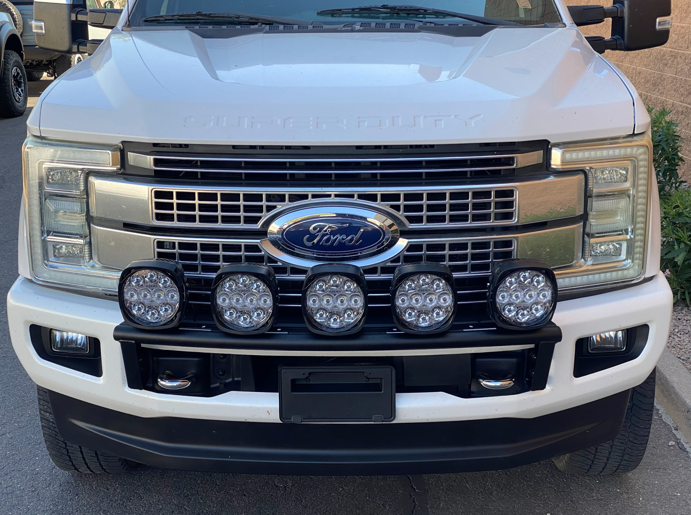 Front view of a 2017-2022 Ford F-250 Super Duty with a light mount kit installed on the stock bumper, featuring multiple LED lights.