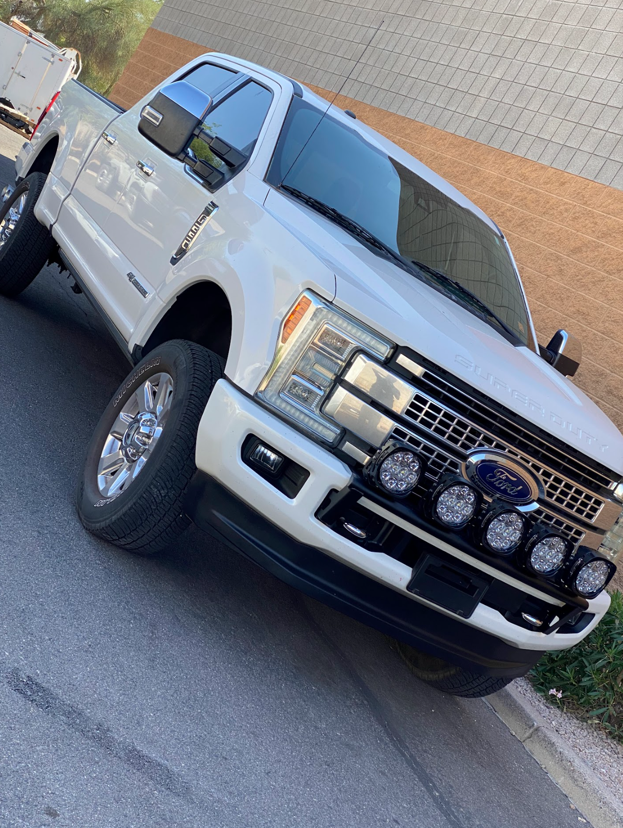 Front light mount kit for 2017-2022 Ford F-250 Super Duty installed on a truck with stock bumper, showcasing offroad lights.