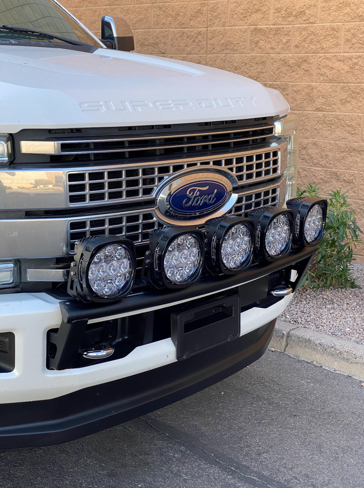 Front light mount kit for 2017-2022 Ford F-250 Super Duty, featuring five LED lights on a stock bumper.