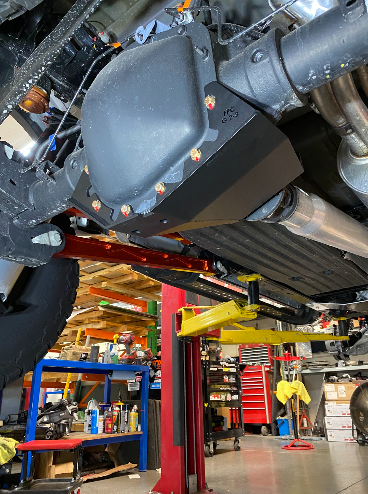 Rear differential skid plate kit for 2017-2024 Raptor, showcasing durable protection and installation under a lifted vehicle.