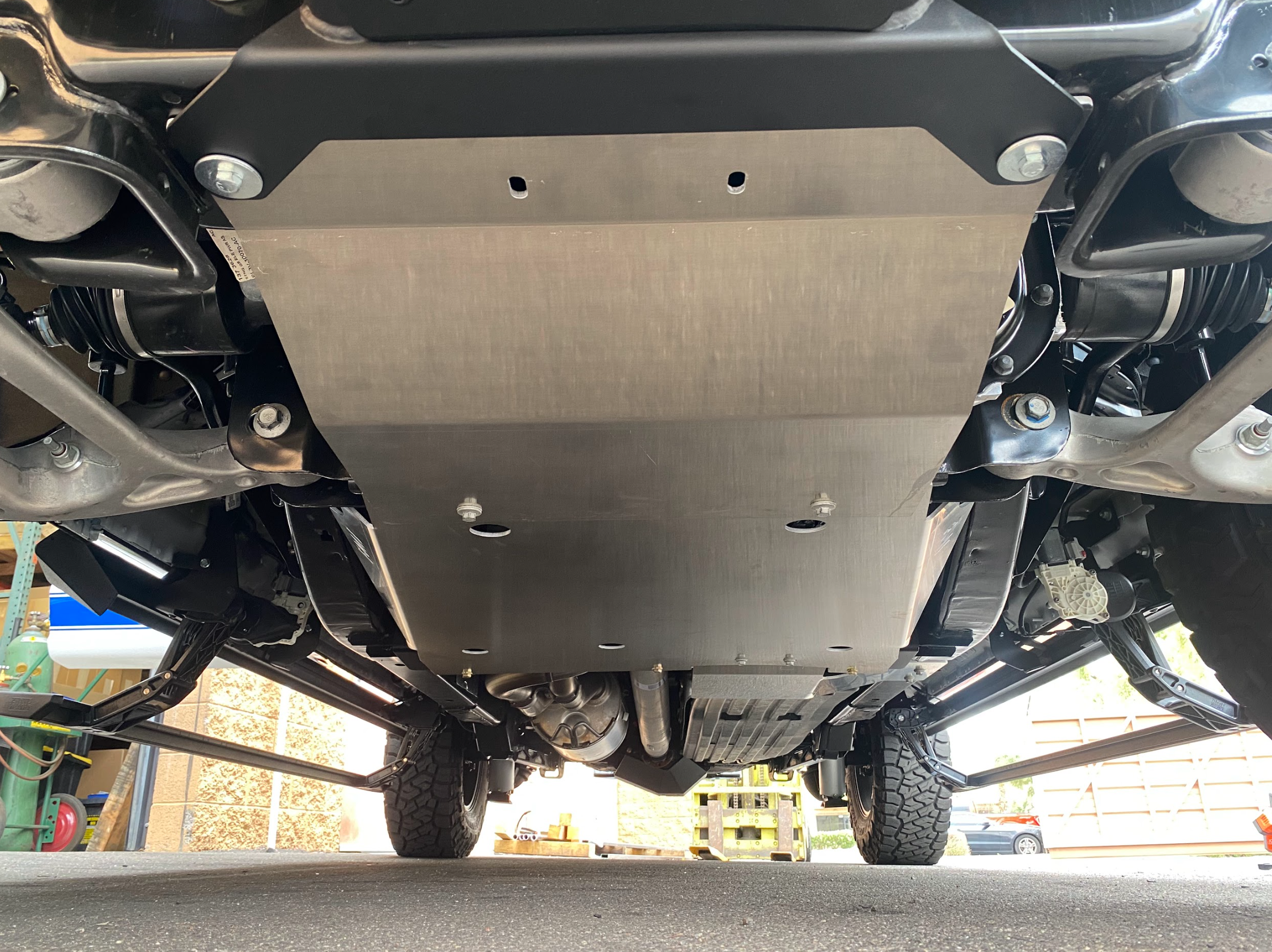 Skid plate kit installed on a 2017-2024 Ford Raptor, showcasing undercarriage protection and rugged design.