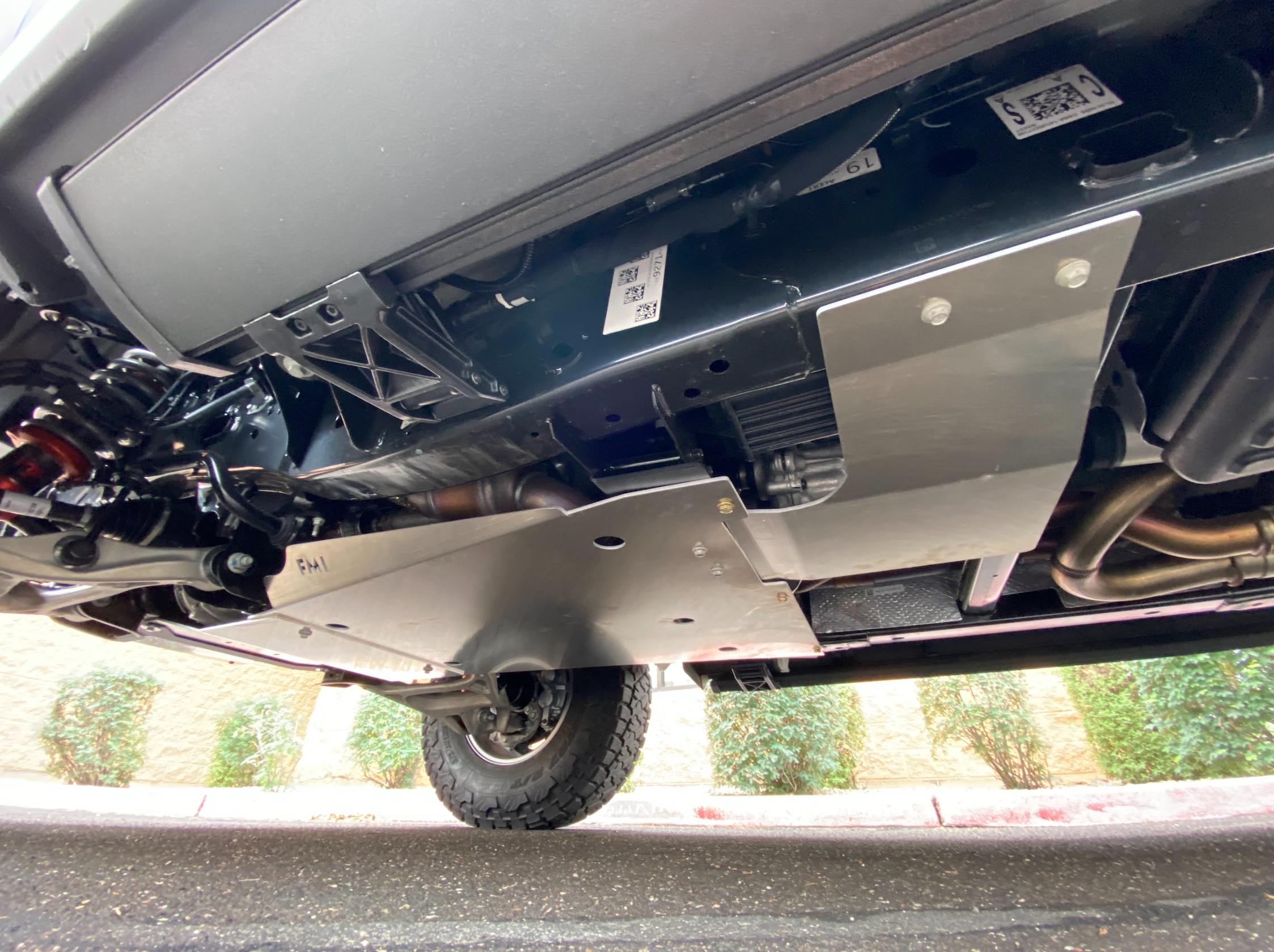 Skid plate kit installed on a 2017-2024 Ford Raptor, showcasing undercarriage protection for off-road use.