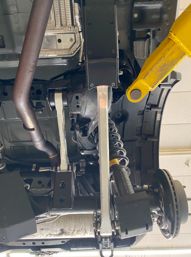 2021 and up Bronco rear lower arm frame guard with HDPE slide installed, showcasing offroad suspension components.
