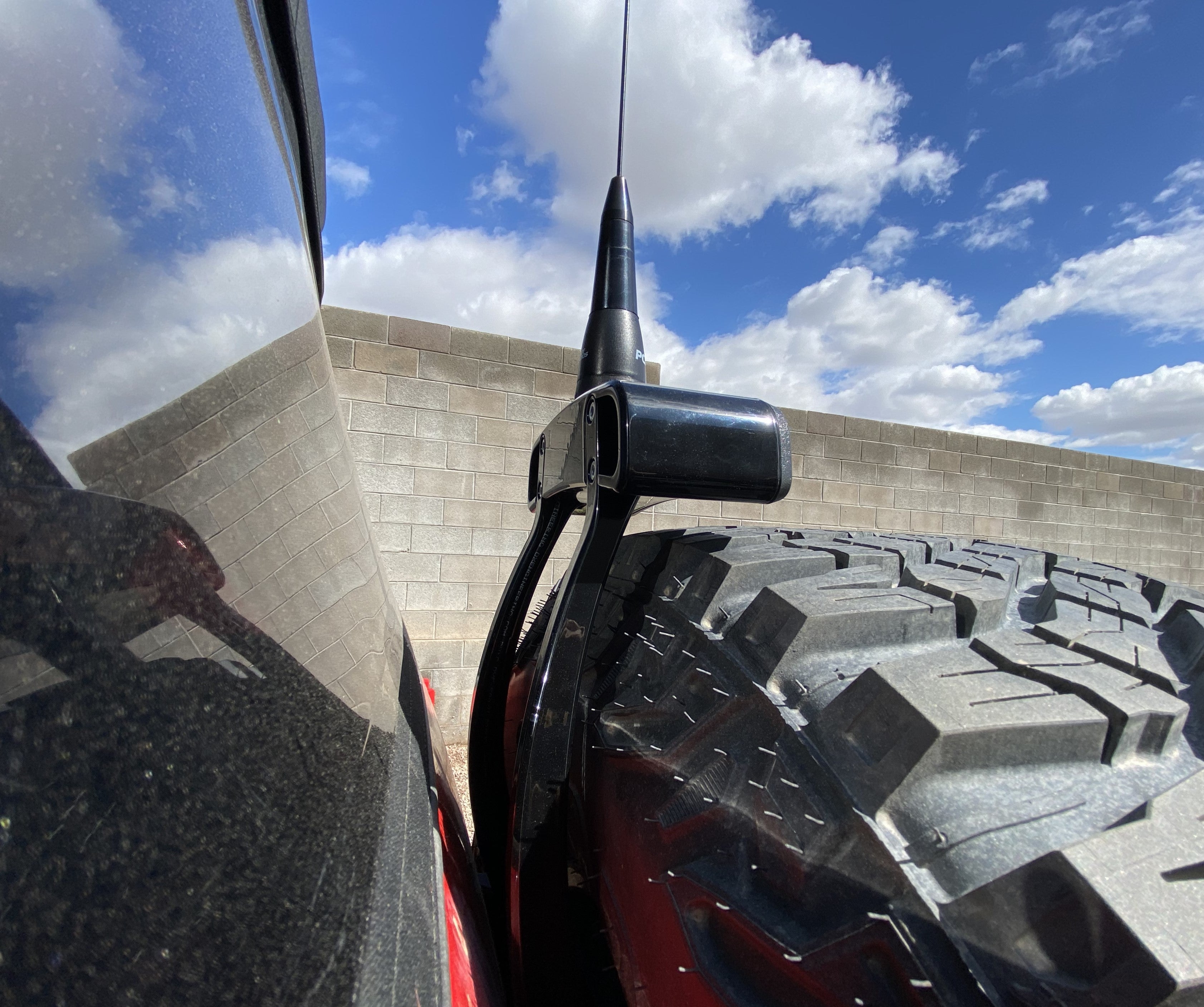 2021-25 Ford Bronco third brake light antenna mount installed on a vehicle with a large tire, showcasing durability and design.