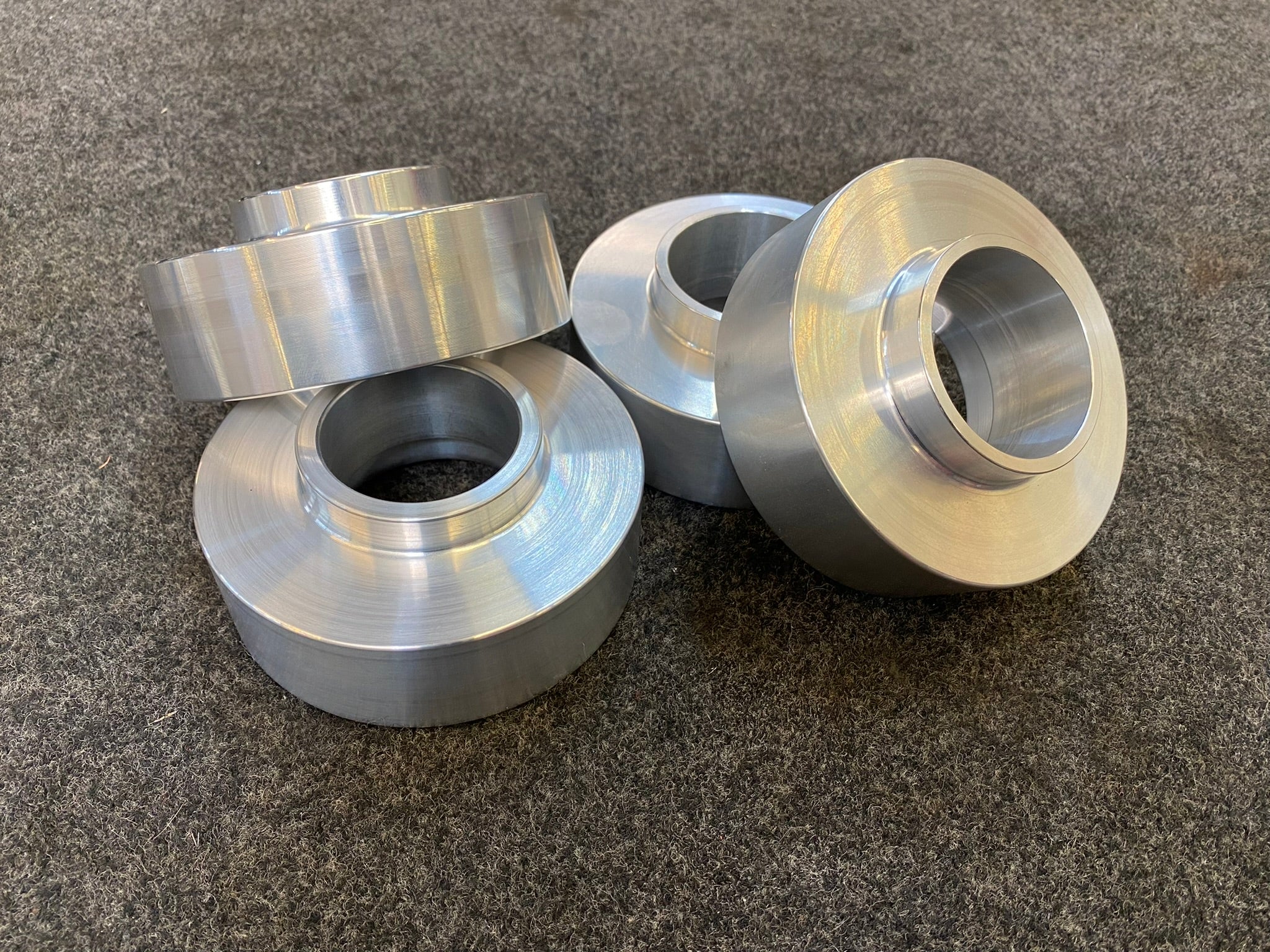 2021-2022 Bronco 1.5-inch rear lift kit components, featuring precision-machined aluminum spacers for enhanced off-road performance.