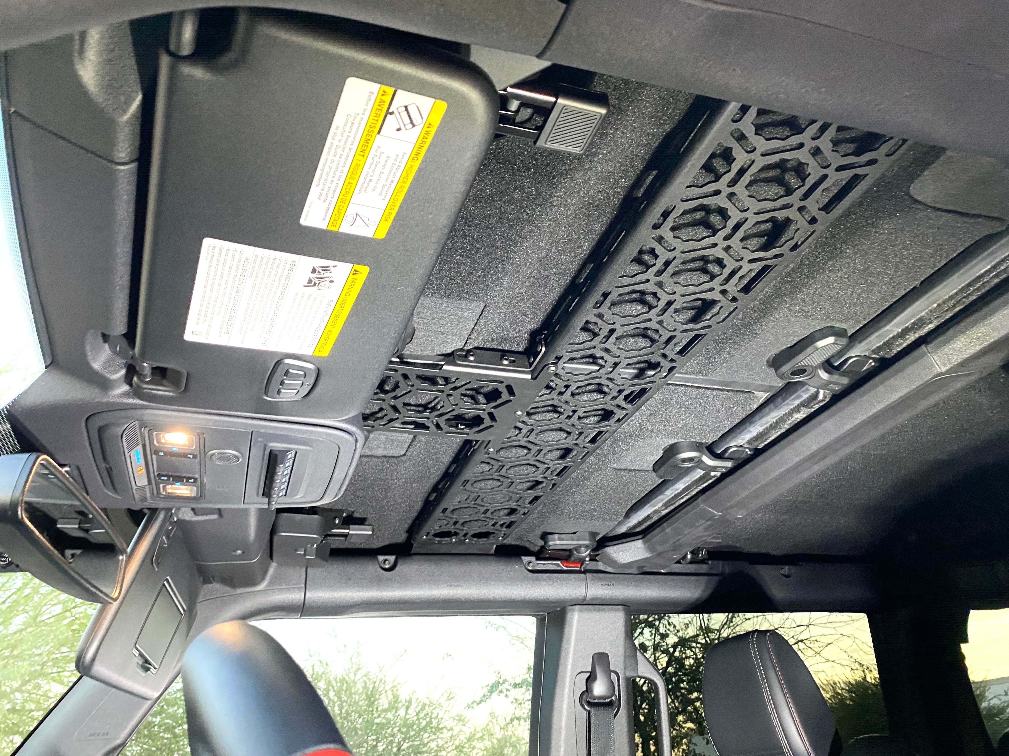 Inside view of a 2021 Bronco roof mount by Adapt-A-Panel, featuring a short front panel and hexagonal design for storage.