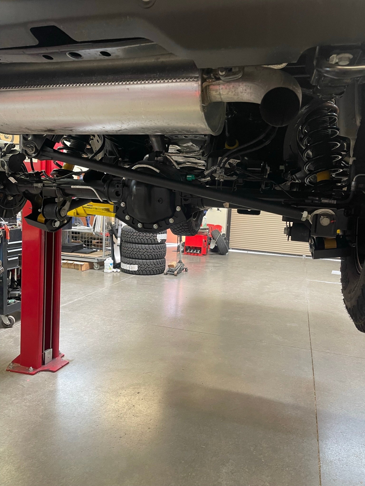 Adjustable panhard bar kit for 2022-UP Bronco Raptor, featuring heim joint design, installed under vehicle.