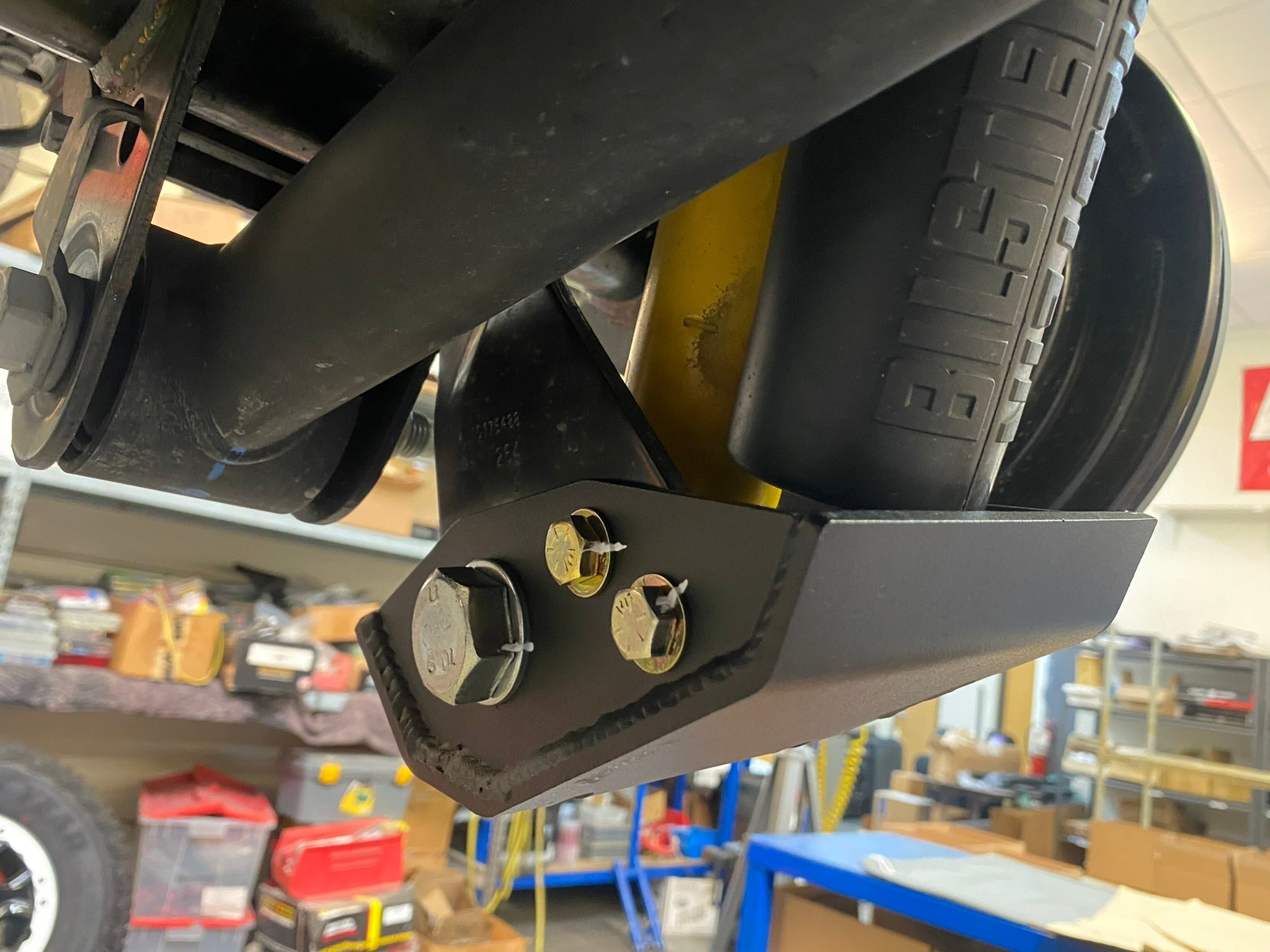 2021+ Bronco rear shock skid kit designed for Squatch and Base Shock, showcasing durable metal construction and mounting hardware.