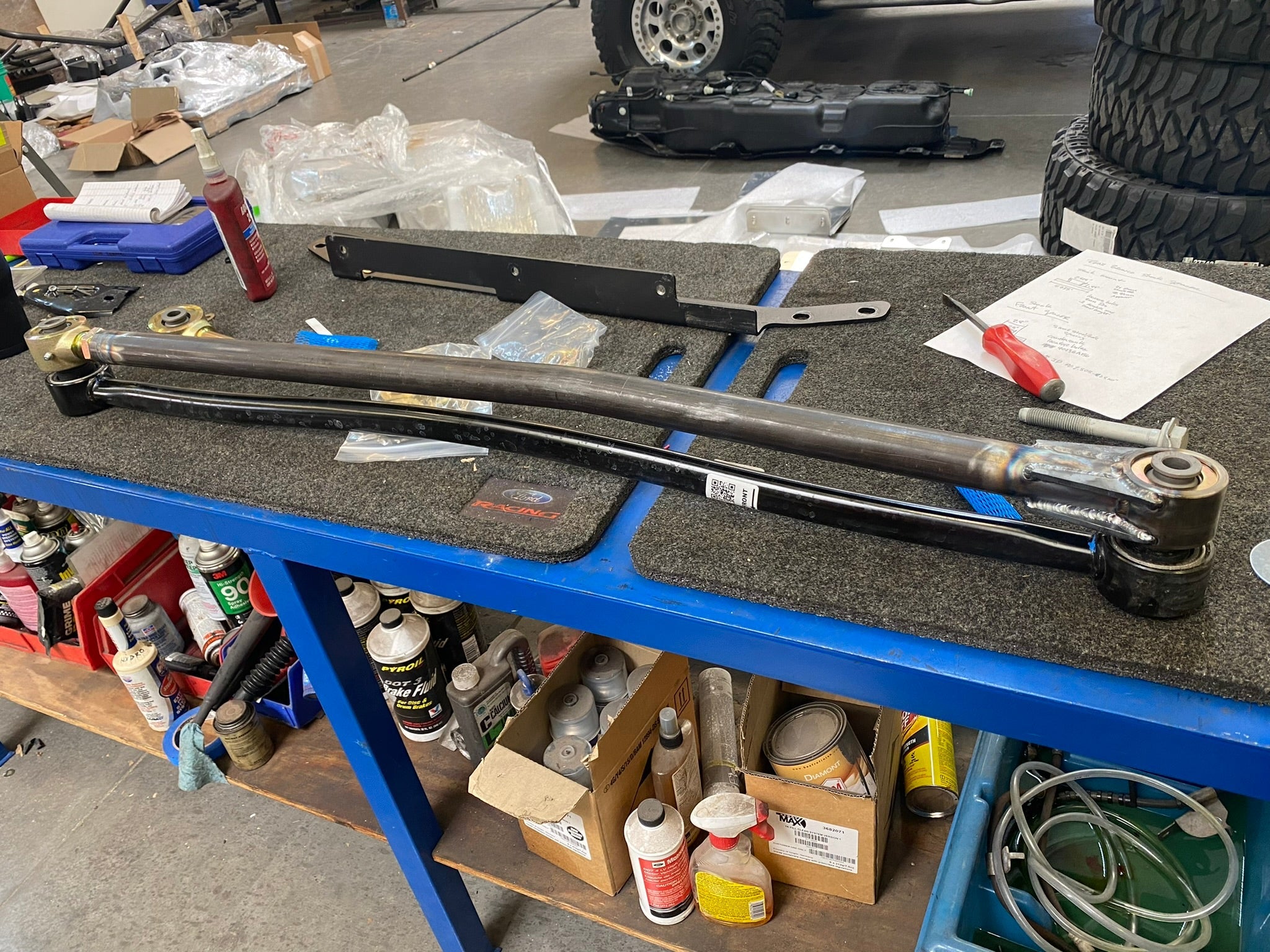Adjustable Panhard Bar Kit for 2021 and newer Bronco featuring Johnny Joint type, displayed on a workshop table.