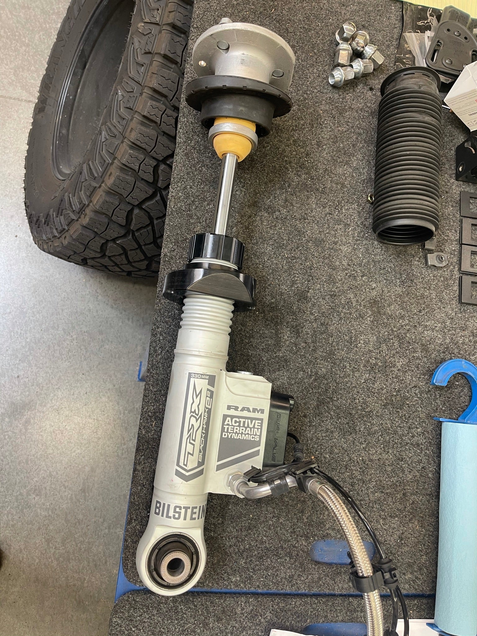2025 Ram RHO 1.5 inch front leveling kit featuring Bilstein shocks and installation components on a workbench.