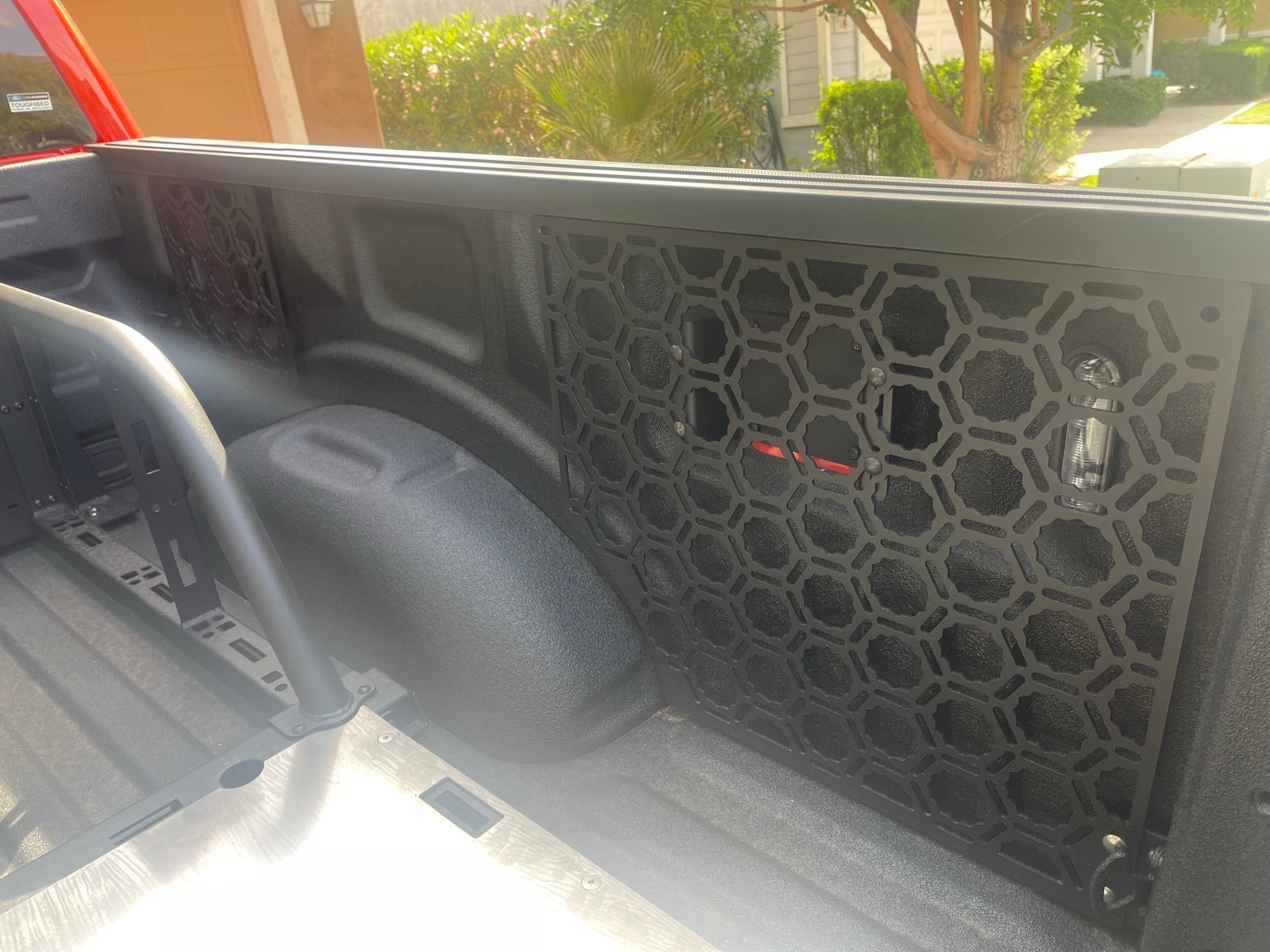 Bedside organizer panel kit for 2021-2023 Ford Raptor and F150, featuring a honeycomb design for efficient storage.