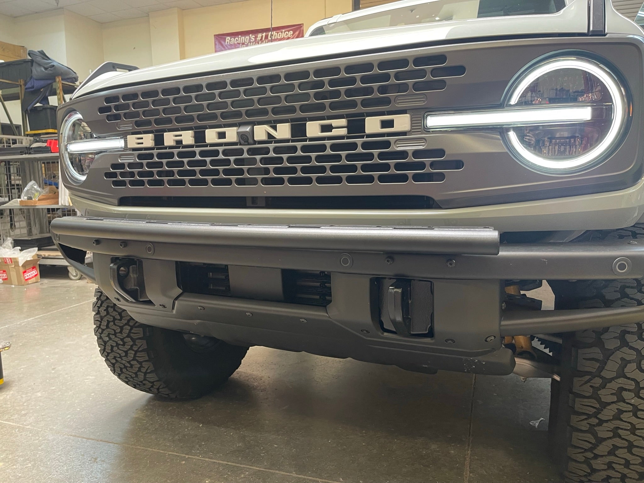 Front view of a 6th Gen Bronco with a Front Light Mount Kit installed on the modular stock bumper, ready for any light.
