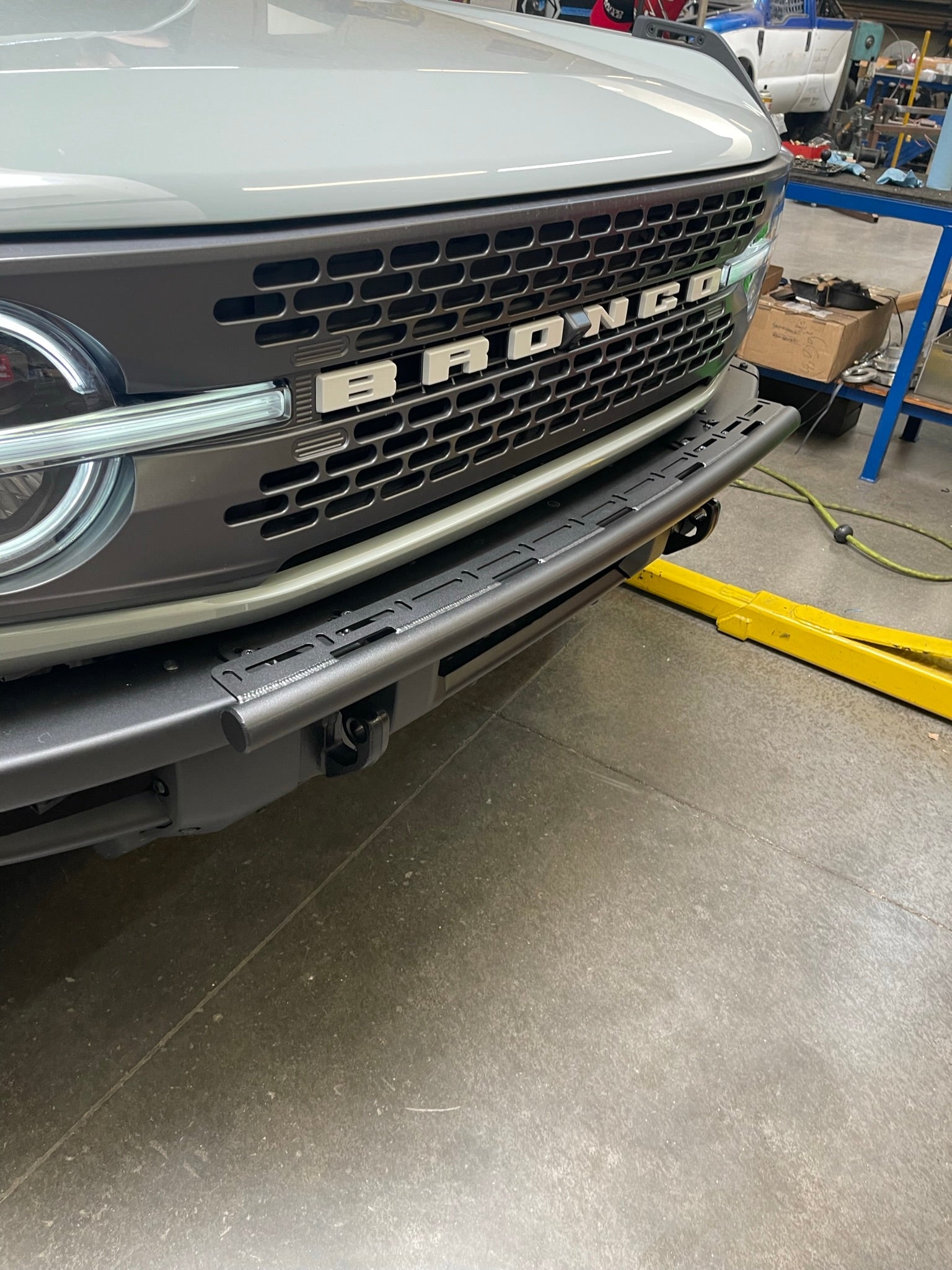 Front view of a 6th Gen Bronco with a front light mount kit installed on the modular stock bumper, showcasing versatility for any light.