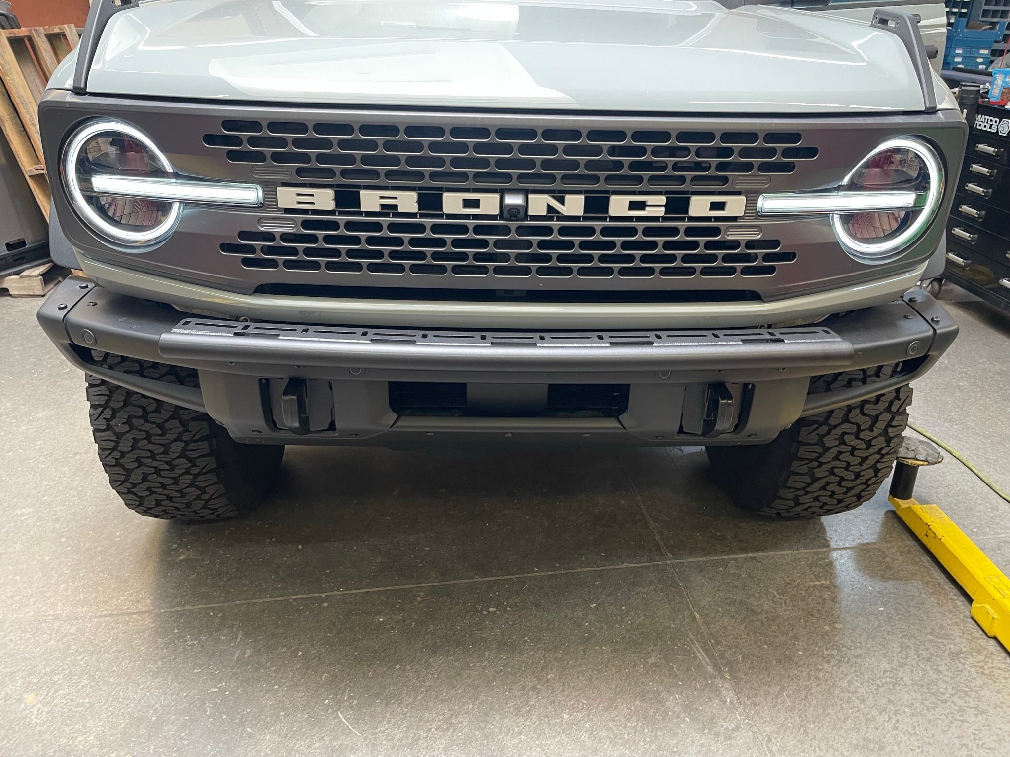 Front view of a 6th Gen Bronco with a Front Light Mount Kit installed on the modular stock bumper, showcasing rugged design.