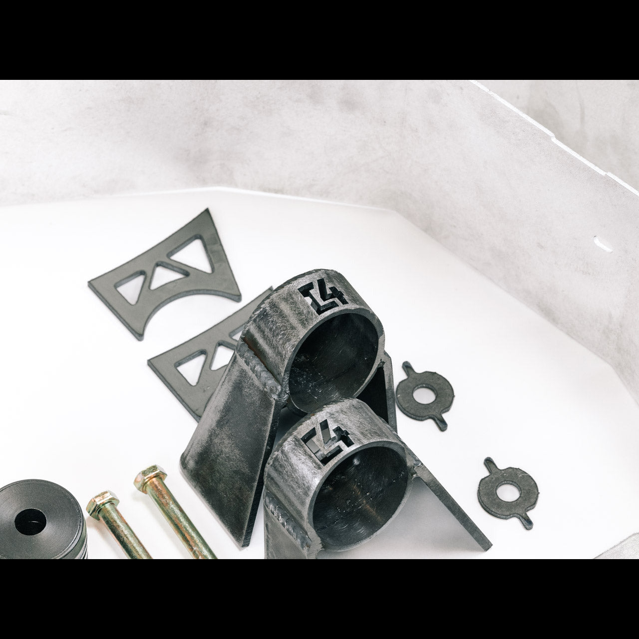 Body mount relocation kit for 3rd Gen vehicles, featuring durable brackets, bolts, and rubber components for enhanced stability.