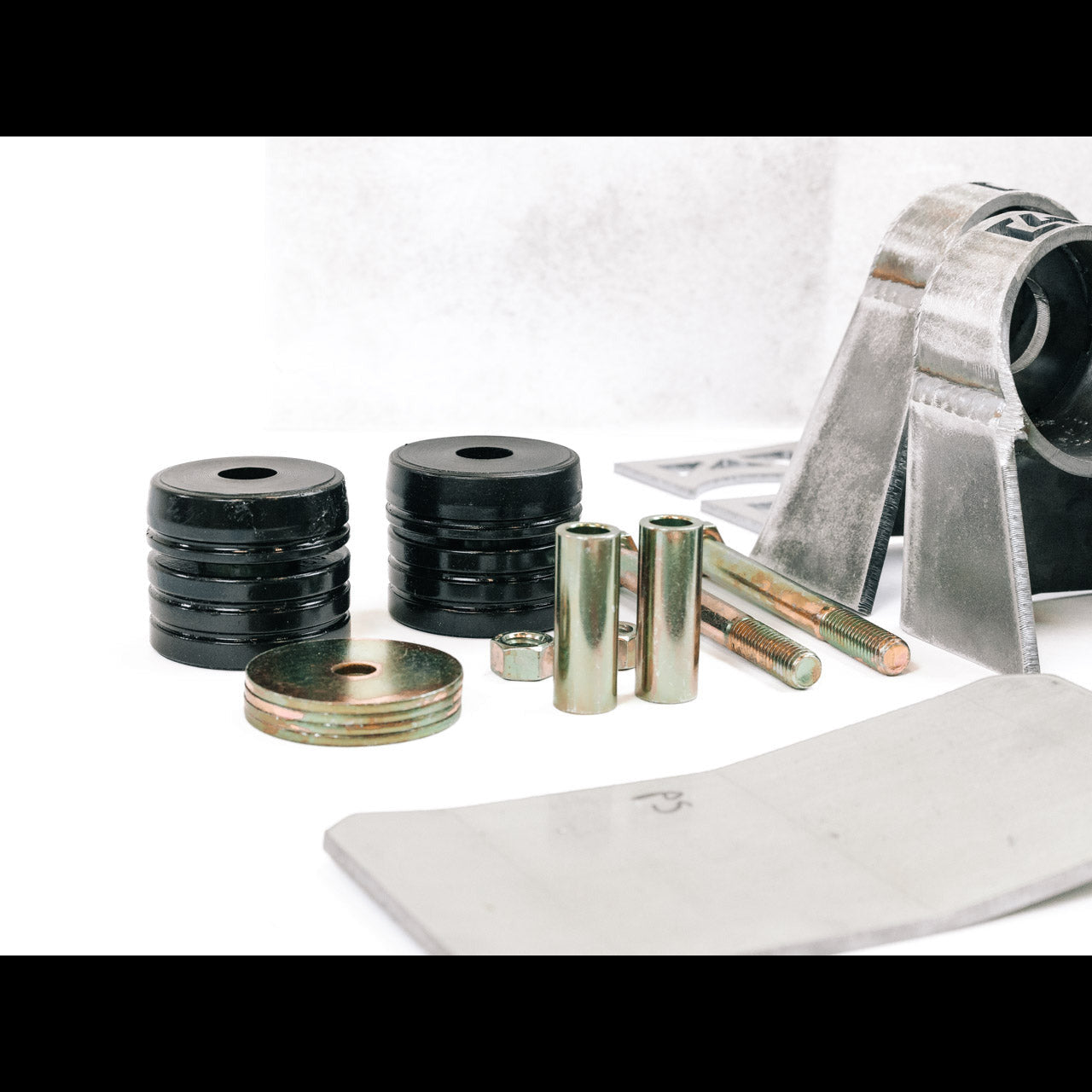 Body mount relocation kit for 3rd Gen vehicles, featuring spacers, bolts, and installation hardware for enhanced performance.