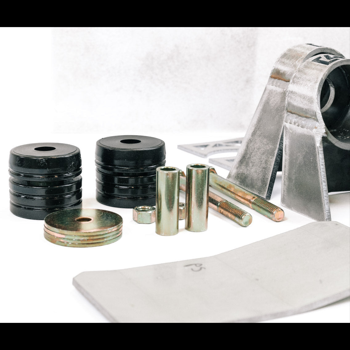 Body mount relocation kit for 2nd Gen vehicles, featuring spacers, bolts, and brackets for enhanced off-road performance.
