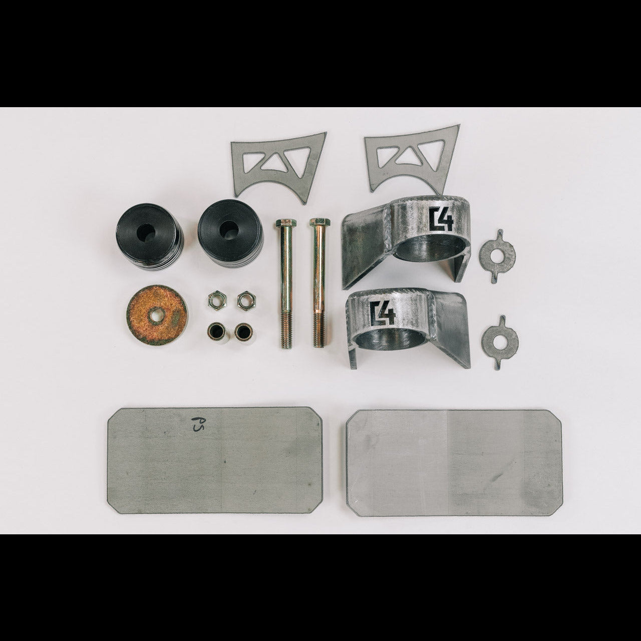 Body mount relocation kit for 3rd Gen vehicles, including brackets, bushings, bolts, and hardware for installation.