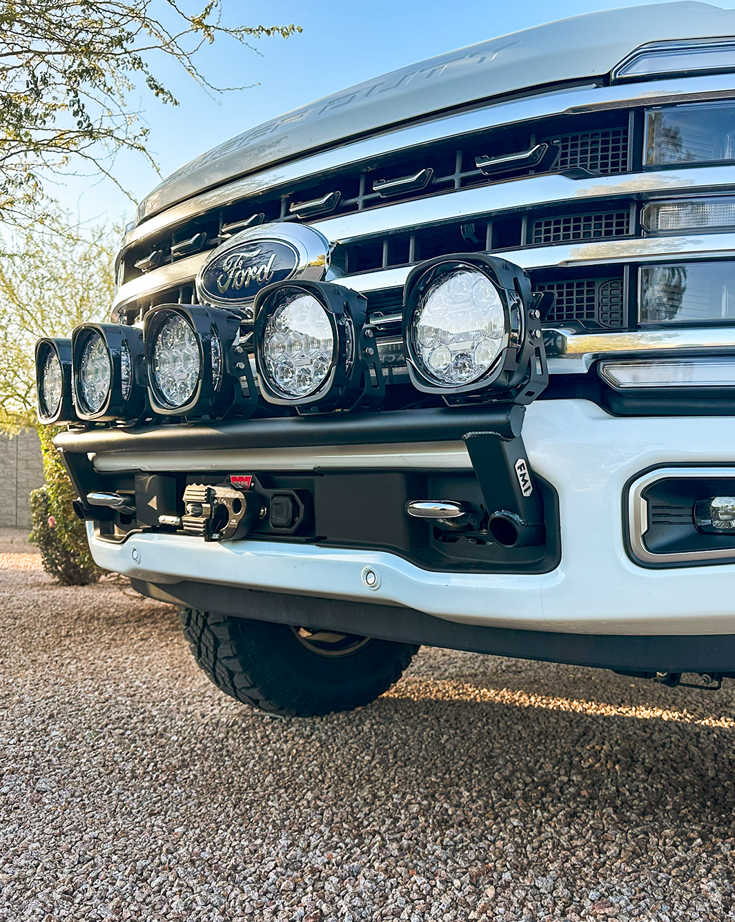 2023+ Ford F-250 Super Duty front light mount kit installed on stock bumper, featuring multiple high-intensity lights.